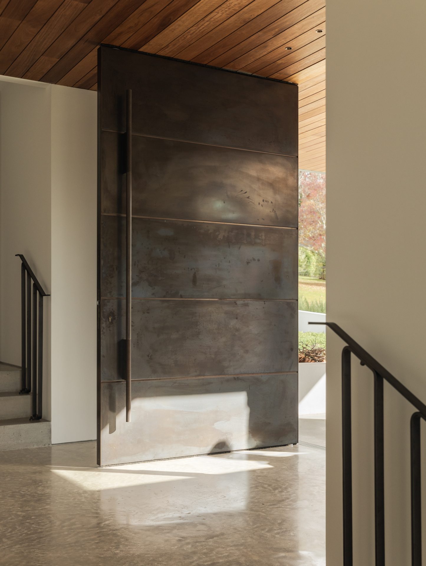 Detail of the bronze pivot door handle at Melody House